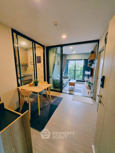 Modern open-plan living room with dining area and balcony view
