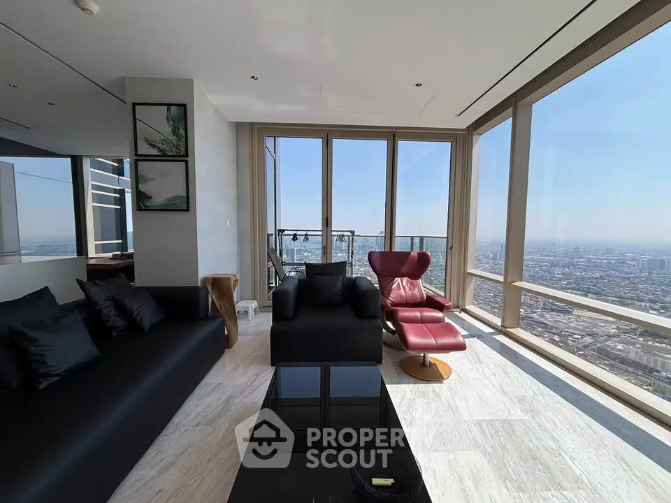 Luxurious living room with panoramic city views and modern furnishings in a high-rise apartment.