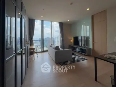 Modern living room with floor-to-ceiling windows offering stunning city views, stylish furniture, and open layout.