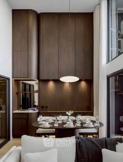 Luxurious modern dining area with high ceilings and elegant wooden cabinetry