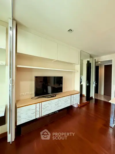 Modern living room with sleek TV unit and hardwood floors