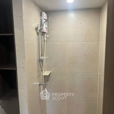 Modern bathroom with sleek shower fixtures and neutral tile design.
