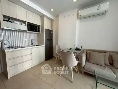 Modern kitchen and living area with sleek design and neutral tones