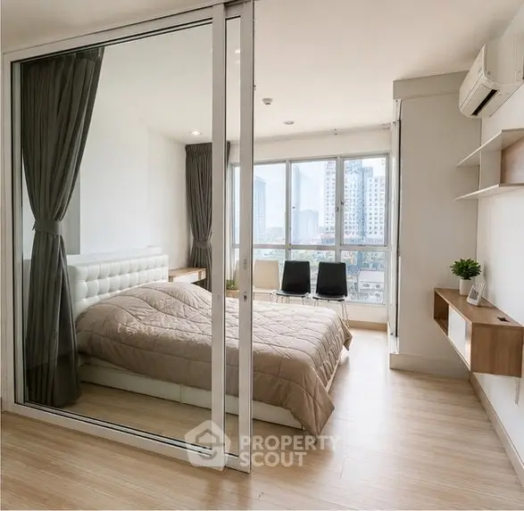 Modern bedroom with glass partition and city view, featuring sleek design and natural light.
