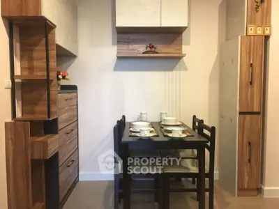 Cozy kitchen with modern wooden cabinets and dining set, perfect for small spaces.
