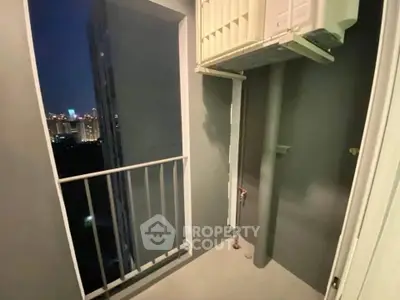 Compact balcony with city view, ideal for urban living in high-rise apartment.