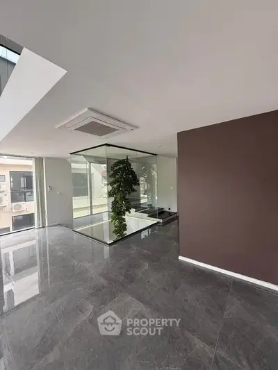 Modern living room with glass enclosure and sleek marble flooring