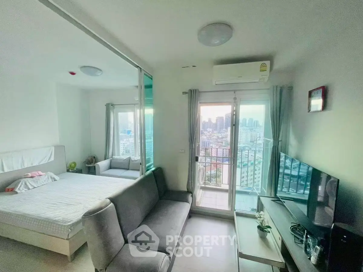 Modern apartment with city view, featuring cozy living area and bedroom, ideal for urban living.