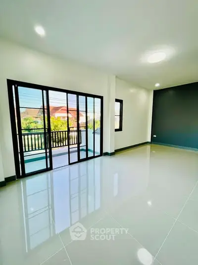 Spacious modern living room with large windows and balcony access