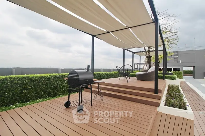 Stunning rooftop terrace with modern BBQ grill and stylish seating, perfect for outdoor entertaining.