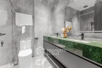 Luxurious modern bathroom with green marble countertop and elegant fixtures