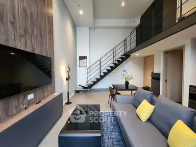Modern loft-style living room with high ceilings and stylish decor