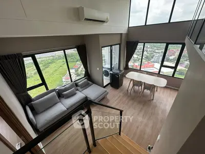 Stunning high-rise living room with panoramic city views and modern decor.