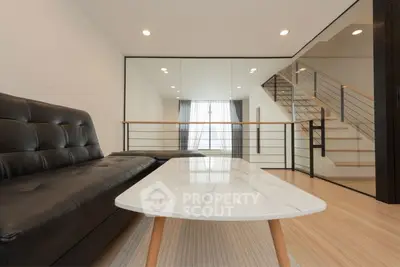 Modern living room with sleek black sofa and elegant marble coffee table