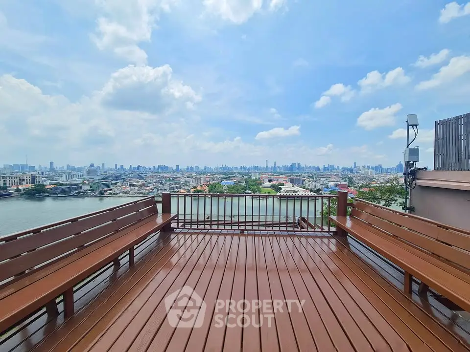 Stunning rooftop deck with panoramic city skyline and river views, perfect for relaxation and entertainment.