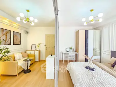 Modern open-plan living room and bedroom with stylish decor and bright lighting.