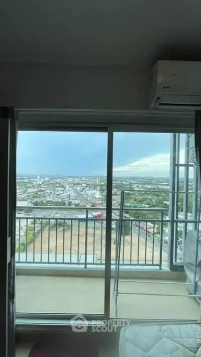 Stunning high-rise apartment with panoramic city view from the balcony, perfect for urban living.