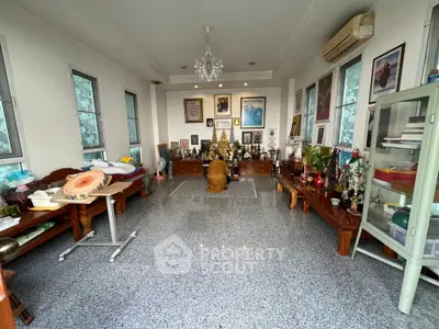 Spacious living room with unique decor and ample natural light