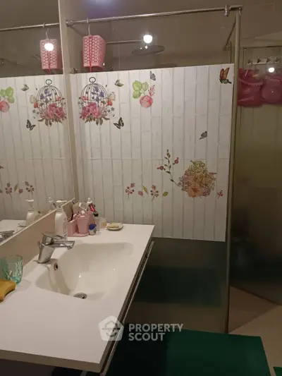 Charming bathroom with floral decor and modern fixtures, perfect for a cozy home.