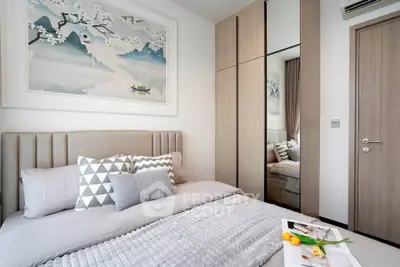 Modern bedroom with stylish decor and mirrored wardrobe