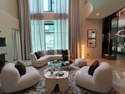Luxurious modern living room with high ceilings, elegant furniture, and large windows for natural light.