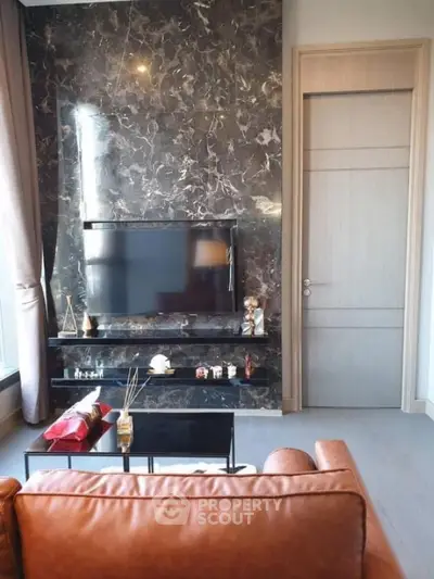 Luxurious living room with marble accent wall and modern TV setup