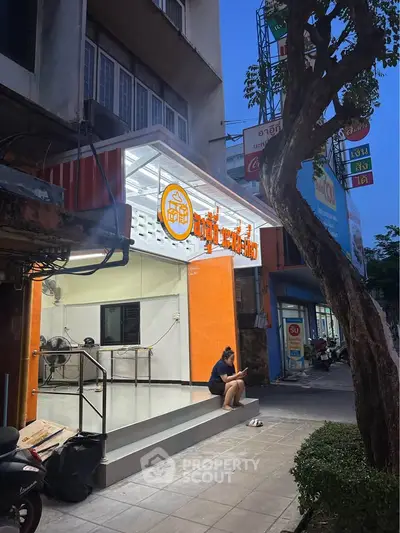 Charming street view of a small commercial property with bright signage and modern facade.