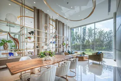 Luxurious modern living room with floor-to-ceiling windows and elegant decor, offering a serene garden view.