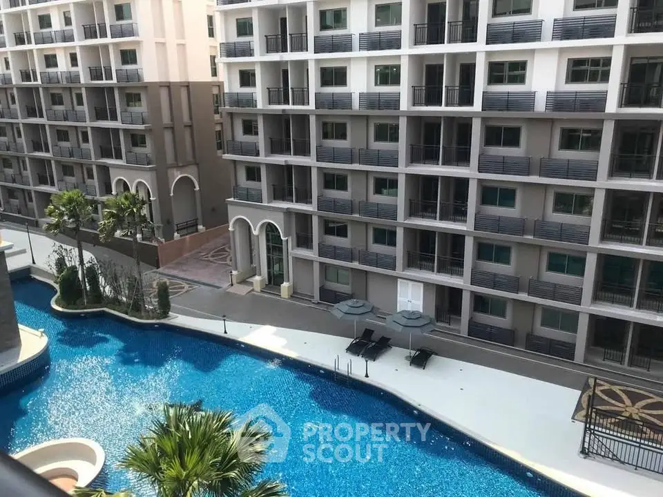 Luxurious condominium with stunning pool view and modern architecture.