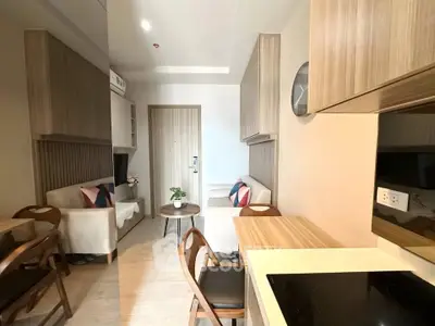 Modern compact living room with open kitchen in stylish apartment
