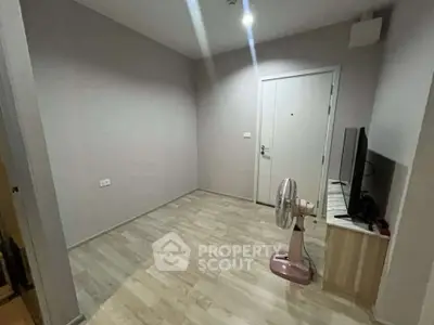 Minimalist room with wooden flooring and a TV stand, ideal for cozy living space.