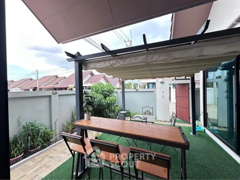 Charming outdoor patio with stylish pergola and lush greenery, perfect for relaxation and entertaining.