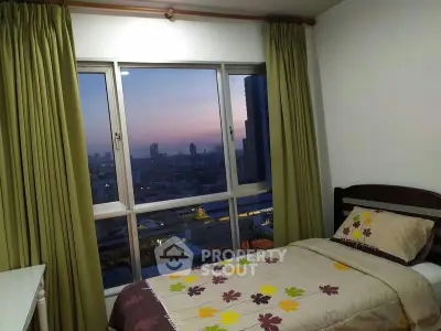 Cozy bedroom with city view, featuring large window and stylish bedding, perfect for urban living.