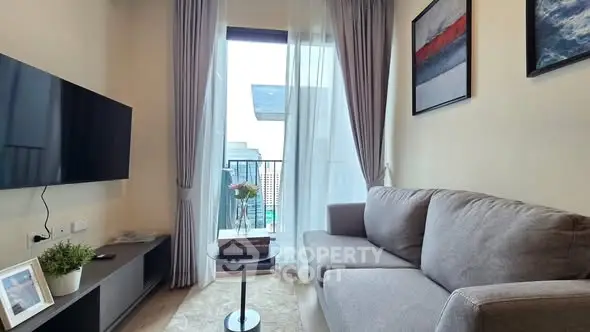 Modern living room with balcony view, stylish decor, and cozy seating area.