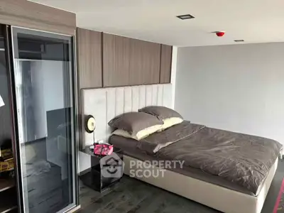 Modern bedroom with stylish decor and cozy bedding in a contemporary apartment.