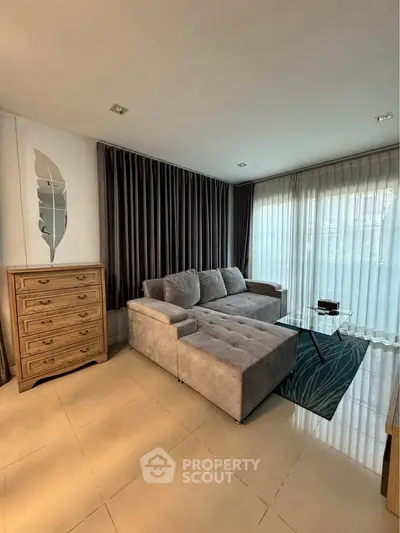 Spacious living room with modern sofa and elegant decor, perfect for relaxation and entertainment.