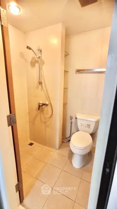 Compact bathroom with shower and toilet in modern apartment