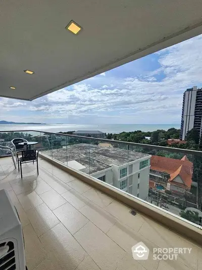 Spacious balcony with stunning ocean view in modern high-rise apartment