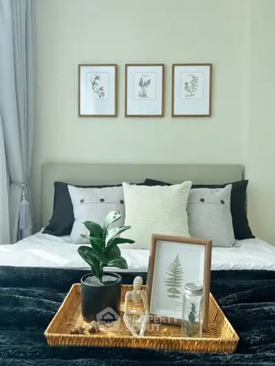 Cozy bedroom with stylish decor and framed botanical art above bed.