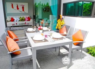 Chic outdoor dining area with modern furniture and vibrant decor