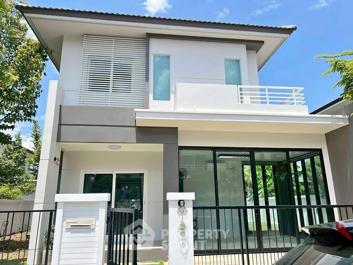 Modern two-story house with sleek design and large windows, perfect for contemporary living.