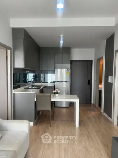 Modern kitchen with sleek cabinetry and dining area in a stylish apartment
