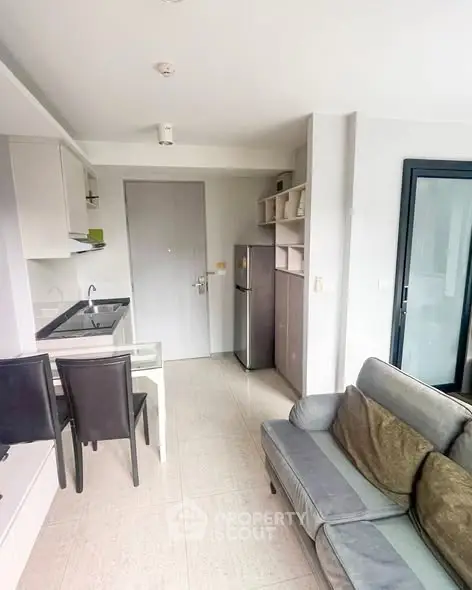 Modern apartment interior with cozy living area and compact kitchen.