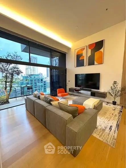 Modern living room with large windows and city view, featuring stylish furniture and contemporary art.
