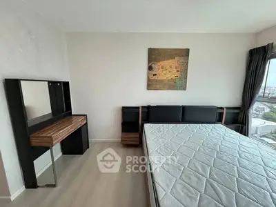 Modern bedroom with stylish furniture and large window offering city views.