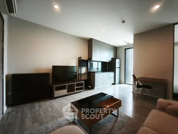 Modern living room with sleek furniture and open kitchen layout