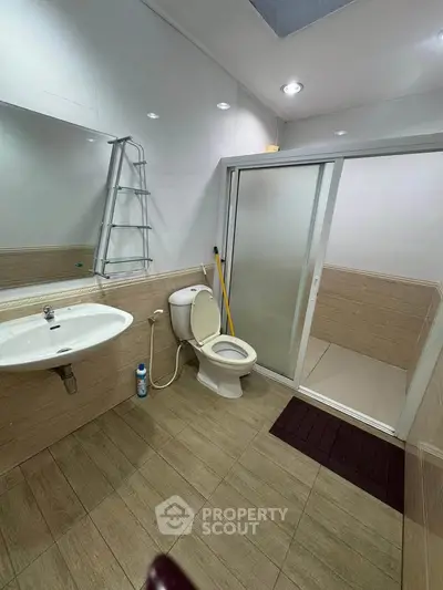 Modern bathroom with sliding glass shower door and sleek fixtures
