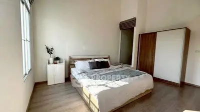 Spacious bedroom with modern decor and ample natural light