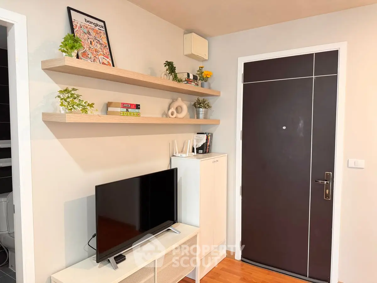 Modern living room with TV, shelves, and stylish decor