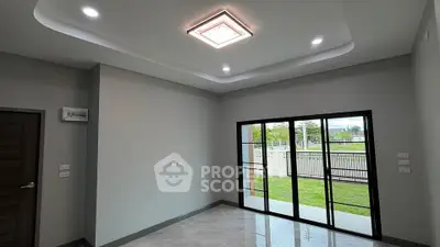 Spacious modern living room with large windows and garden view, perfect for natural light lovers.